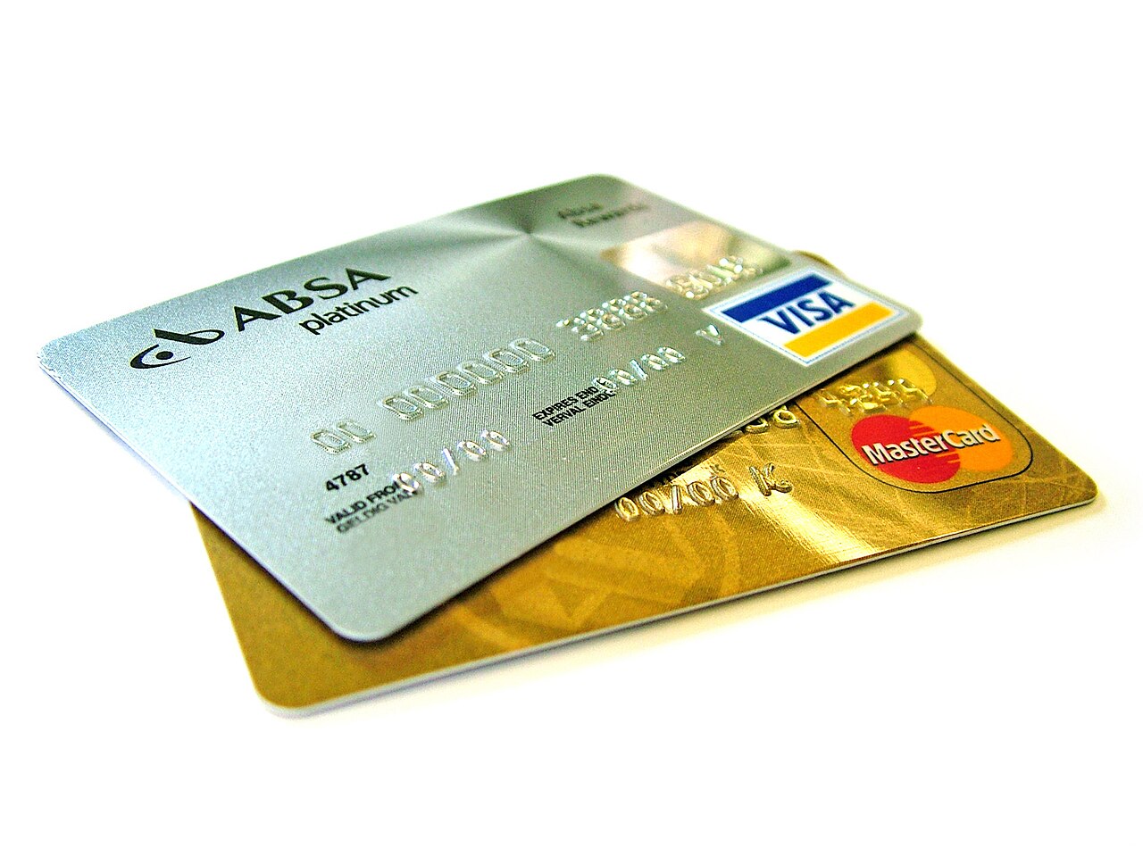 A platinum Visa card and a gold Mastercard overlapping on a white surface